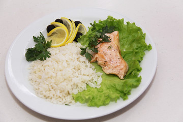 Freshly seared piece of salmon resting on a plate  with brown ri