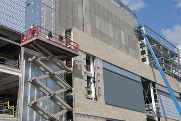 A Scissor Lift  and a cherry picker on a construction site