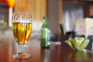 Glass of beer on a bar counter.