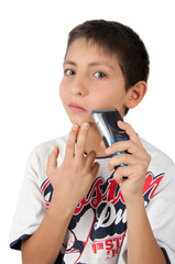 kid boy holding shaver razor and shaving cheek