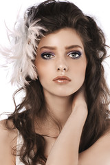 Fototapeta premium girl with long curled hairstyle and feather accessory