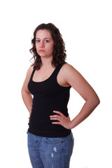 Fototapeta premium Young Brunette in Black Tank Top and Blue Jeans Hands on Hips to