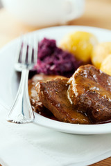 Roast beef with potato dumplings and red cabbage