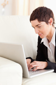 Close up of a Businesswoman lying on a sofa with a laptop