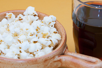 pop corn in bowl and cola