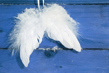 White angel wings on blue background
