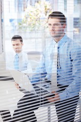 Fototapeta premium Young businessmen working in bright office