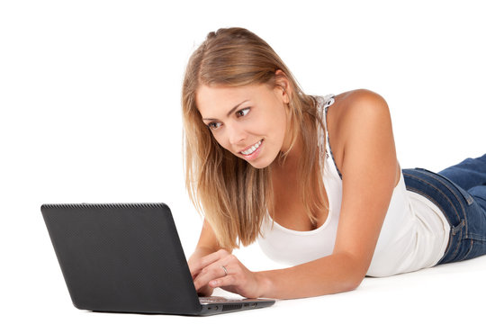 Woman with laptop lying down on the floor