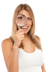 Young smiling female looking through the loupe at you