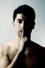 Sexy man in silence gesture