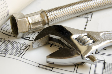 Plumbing tools over house blueprint