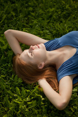 girl lying on the grass and sleeping peacefully