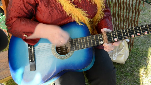 woman hands playing with guitar