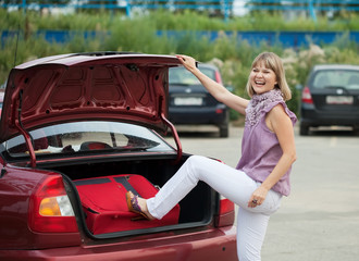 woman packing her baggage into the car
