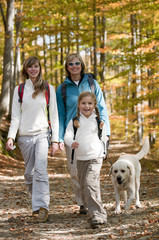 Fototapeta premium Autumn - Family with dog on autumn trek