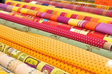Rolls of fabric on a market stall