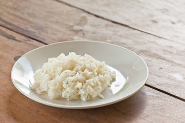 Thai food, jasmine rice cooked on plate, on  wood background