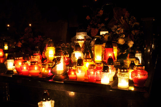 Group of candles on grave during All Saint's Day