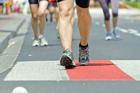 People running in marathon on city street