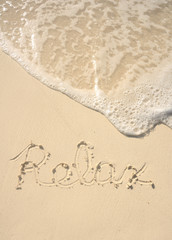 Relax Written in Sand on Beach