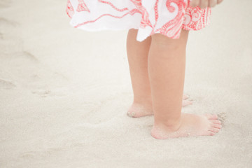 Childs feet on the sand