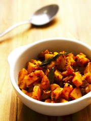 close up of a bowl of spicy curry potatoes
