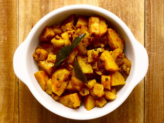 close up of a bowl of spicy curry potatoes