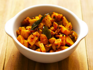 close up of a bowl of spicy curry potatoes
