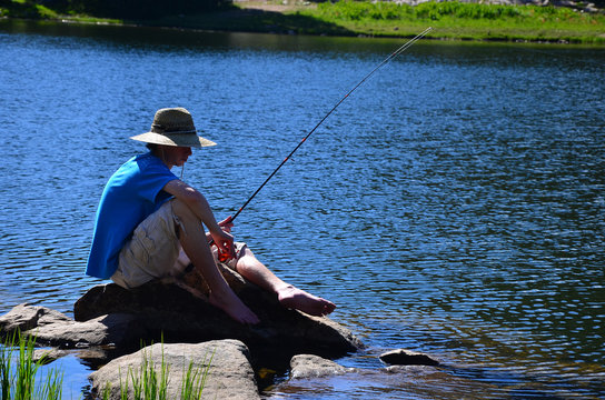 Teenage Boy Fishing on a Lake