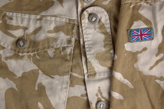 British army desert uniform jacket and a flag