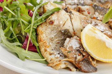 Grilled fish fillet with tomato and lemon