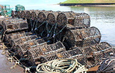 A Stack of Lobster and Crab Pots on a Harbour Wall.