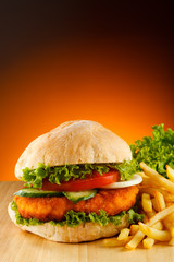 Big hamburger, French fries  and vegetables