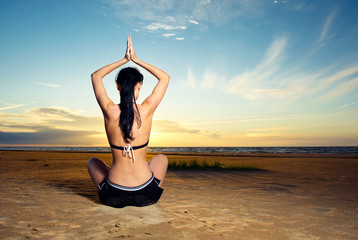 Fototapeta na wymiar Woman doing yoga exercise outdoors