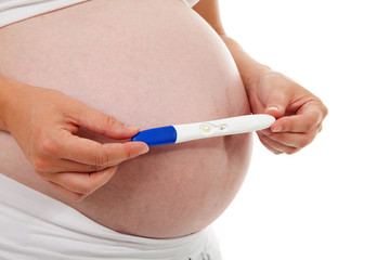 Woman is holding pregnancy test