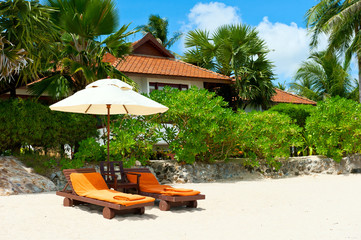 Beach chairs on tropical white sand beach