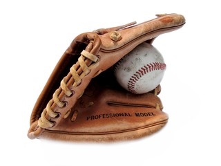 Old baseball mitt with baseball isolated on white.