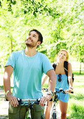 Obraz premium Young happy couple riding a bicycle
