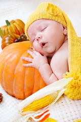 Baby sleeping on a pumpkin