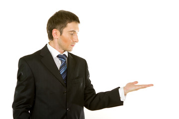 Young man in a suit showing something