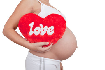 Pregnant woman hold red hart with love in hands