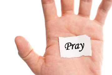 Pray words type on paper on hand