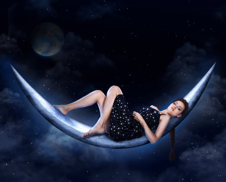 Fantasy beautiful young woman lie over moon