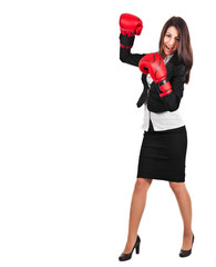 A business woman with boxing gloves punching