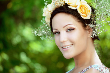 Beautiful woman with a wreath of roses