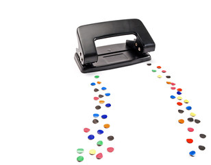Hole puncher leaves a trail of colored circles.
