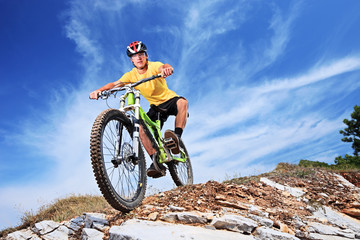 A young male riding a mountain bike