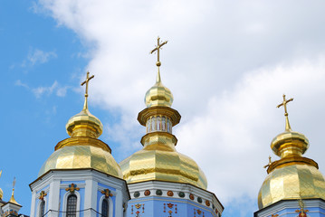 Fototapeta na wymiar Gold domes against clouds