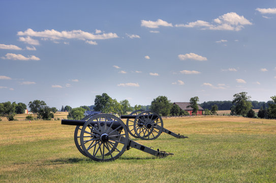 Two Civil War Era Cannons In Open Field