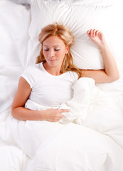 Naklejka premium Young woman in bed.